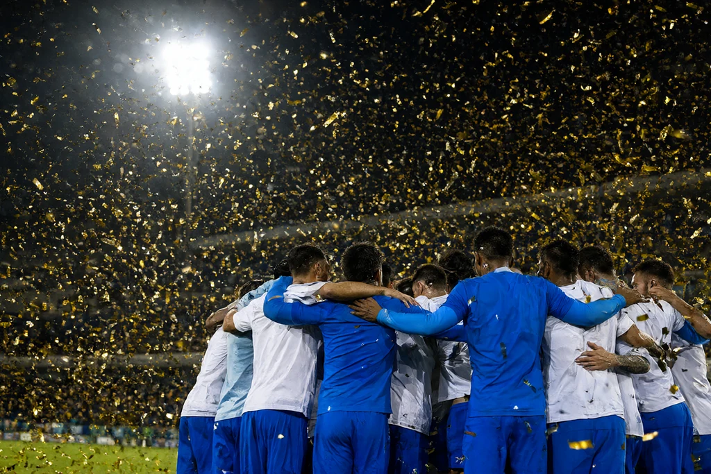 Golden confetti drifting over dark stadium lights